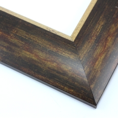 This bold, 2.5 " frame features a reverse profile design; it slopes from thickest at the inner edge to thin at the outer.  Overlapping brown, gold and deep red layers result in a faux wood-grain, rustic effect.  The cracked gold foil inner edge slants in toward the artwork. 

Best suited to large artwork; the perfect border to a rural or autumnal reproduction.