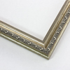 This thin elegant frame is made out of wood with an antique silver finish. It features a distressed border on the inner and outer edge of the profile. As well as displays intricate designs and beading to illuminate its traditional vintage appeal.